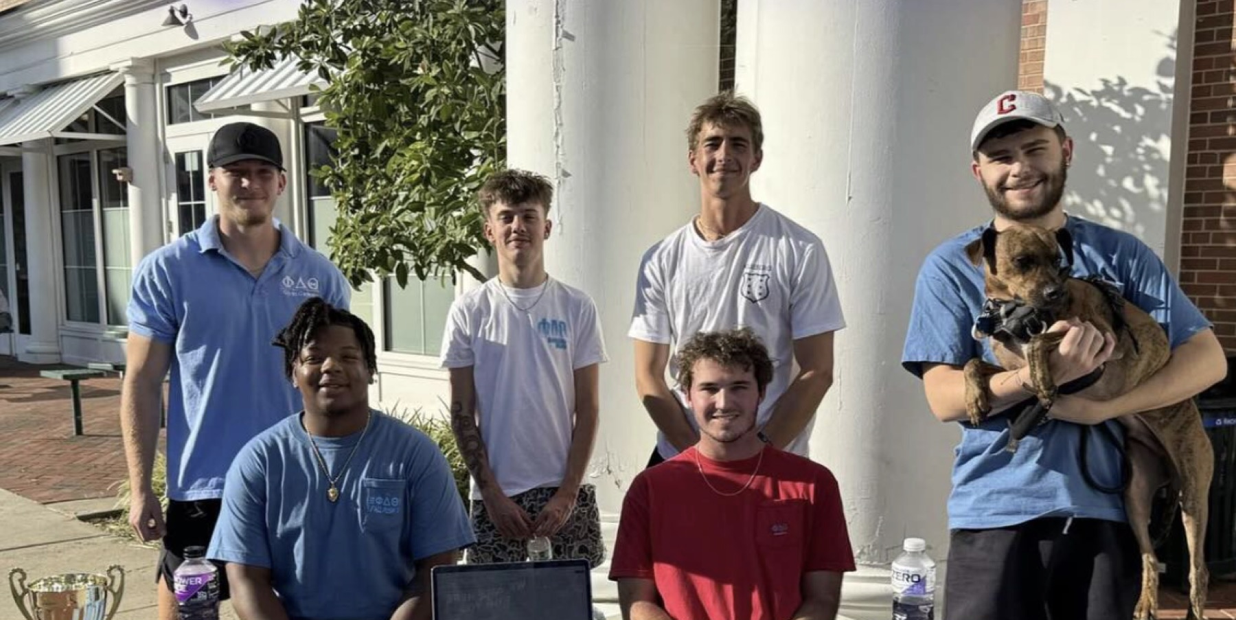 Phi Delta Theta members outside the house